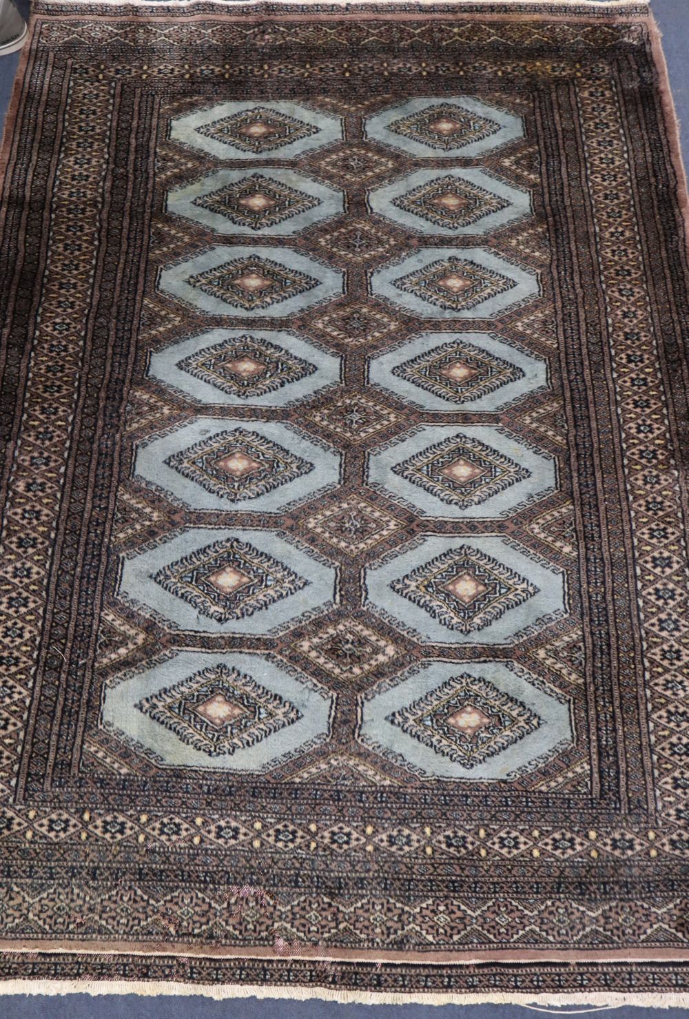 A Bokhara blue ground rug, 180 x 130cm